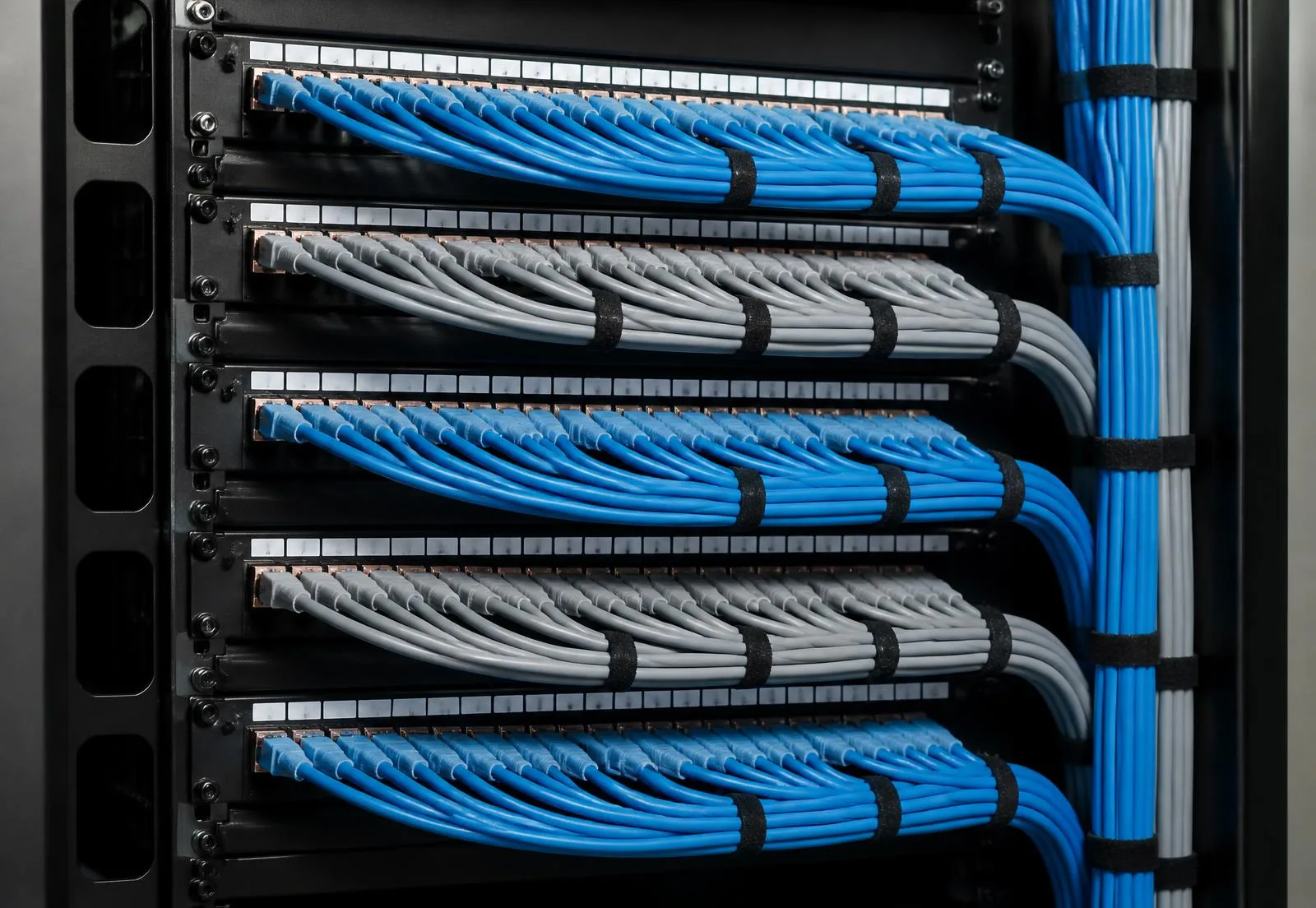 Structured cabling patch field with neatly combed copper patch cords and labeled ports